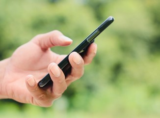 Hand holding a phone outside