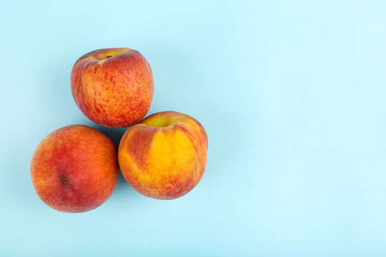 Fresh peaches on blue background