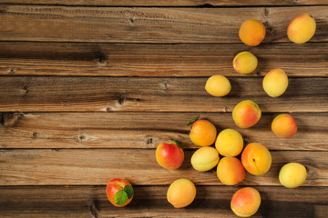 Sweet apricots on brown wooden table