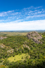 Fototapeta na wymiar Beautiful aerial view of Serra do Cipo in Minas Gerais with forests and rock mountains in sunny summer day with blue sky. Landscape of the Brazilian Cerrado, one of the most devastated biomes.