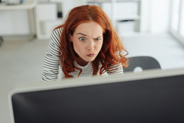 Puzzled young businesswoman pulling a funny face