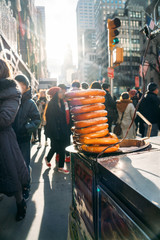 Nine pretzels stacked in a fast food cart in downtown New York City