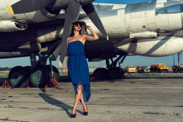 Brunette in a dress at the old airport