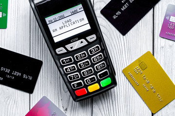 payment card through terminal in store top view wooden background