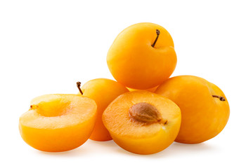 Yellow plums and two halves on a white, isolated.