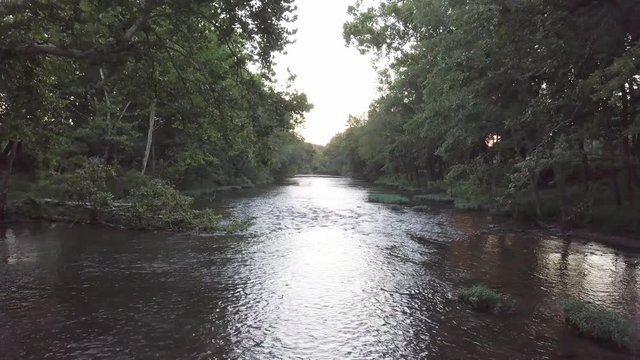 Missouri stream flowing water with trees along the bank