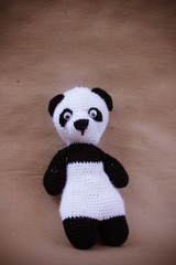 knitted toy panda on craft paper © Ксения Куприянова