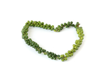 Green pepper bunch put in the heart shaped on white background