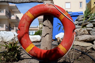 Red lifebuoy as a warning sign of danger