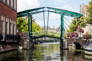 View of old drawbridge and New Rhine river in Leiden downtown at summer time from boat.- Image