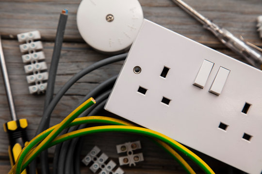 Electrical tools and equipment on a wooden background