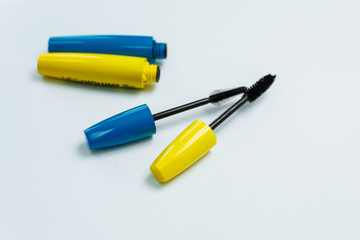 yellow and blue mascara on a white background