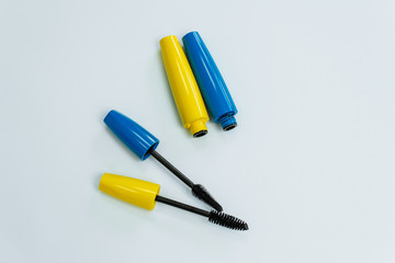 yellow and blue mascara on a white background