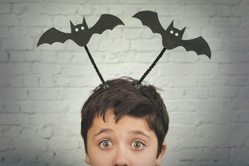 Happy Halloween.funny child with halloween vampires over on his head