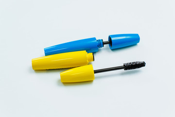 Fototapeta premium yellow and blue mascara on a white background