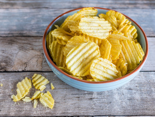 potato chips in bowl on wooden table