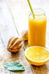 freshly squeezed orange juice in glass bottle on wooden background