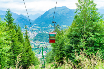 Colorful vintage gondola of Mount Katrin cable car and panoramic alpine view of peaks over Bad Ischl, Salzkammergut, Austria © beataaldridge