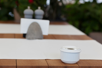 Empty ashtray on the table in park cafe. Modern design interior. Concept of vacation and leisure