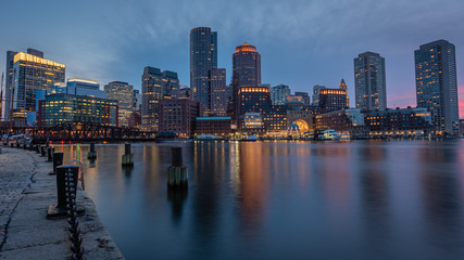 Fototapeta na wymiar Boston skyline at dusk as seen from Fan Pier on Boston Harbor.