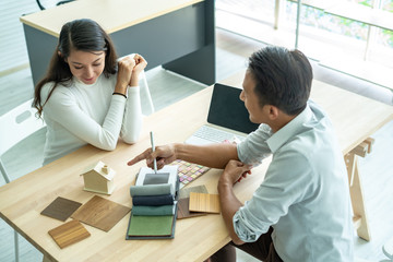 The best choice of house.House owner and architect discussing a choice.Couple dreaming of new home.