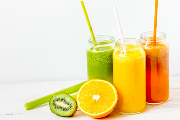 freshly squeezed juice in glass bottle on wooden background