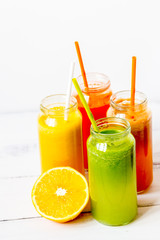 freshly squeezed juice in glass bottle on wooden background