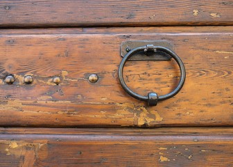 The knocker on the old wooden house door