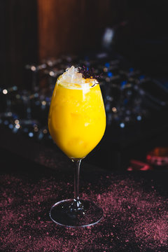 yellow cocktail in a wine spritzer glass