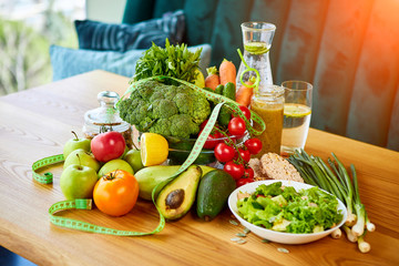 Diet weight loss breakfast concept with tape measure, organic fruits , vegetables, salad and fresh water. Healthy nutrition concept, Lifestyle and Eating