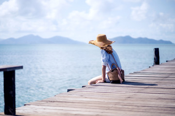 An alone woman sitting on the wood bridge  - Koh mark, Thailand