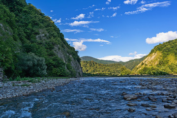 Fototapeta na wymiar Mountains and stormy river. Summer view. Caucasus mountains.