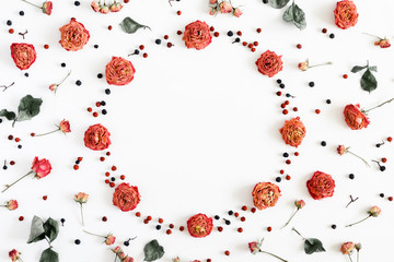 Autumn creative composition. Wreath made of berries, dry roses, flowers on white background. Thanksgiving Day concept. Fall, autumn background. Flat lay, top view, copy space