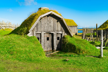 Fototapeta na wymiar Traditional antique Viking village. Old wooden houses near Vestrahorn mountains on the Stokksnes Peninsula, Hofn, Iceland. Popular tourist attraction.