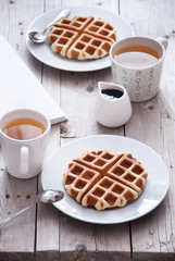 Breakfast - waffles and tea on a wooden table