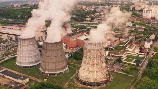 Smoke from chimneys of thermal power plant oe station, aerial view from drone