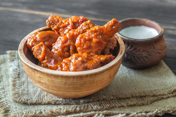 Bowl of buffalo wings with blue cheese dip