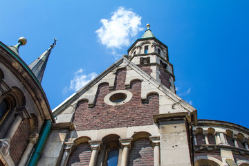 Bottom view of details of the roof of gothic cathedral in Lviv, Ukraine with blue sky on the background