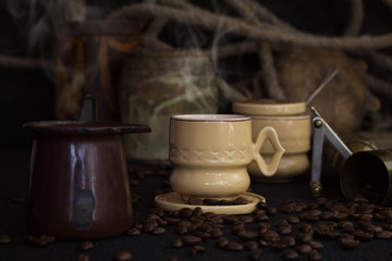 Vintage Coffee Cup, Pot, Grinder With Coffee Beans On a Rustic Wooden Surface