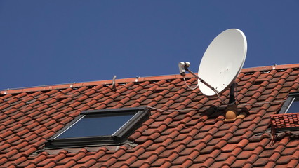 Satellite dish on red roof