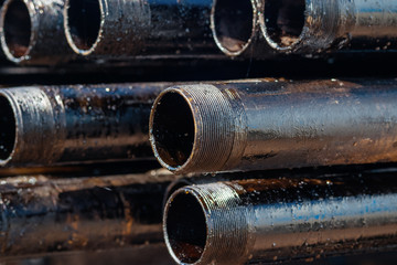 Close up drill pipe thread with pipe dope grease lay down on rig floor at oil and gas on shore location.