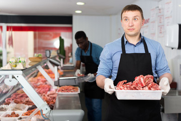 Butchers working behind counter