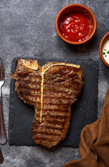 Grilled T-bone steak on dark background
