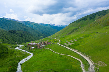 View of the Ushguli village at the foot of Mt. Shkhara. Picturesque and gorgeous scene. Rock tower towers and old houses in Ushguli.