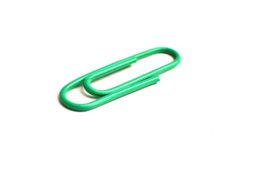 Paper clips, made of iron, are curved in a white background