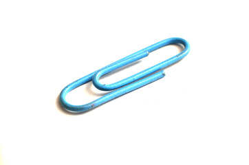 Paper clips, made of iron, are curved in a white background