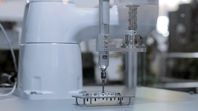 Automatic robot arm working in industrial environment closeup footage