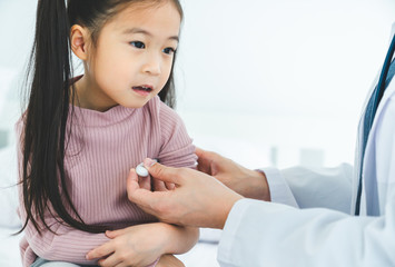 Medical specialist holding stethoscope checking heart lungs of kid doing pediatric checkup in hospital, children medical insurance care.
