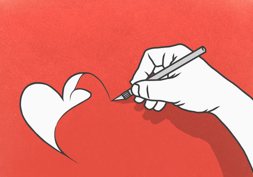 Hand cutting heart-shape out of red paper with scalpel