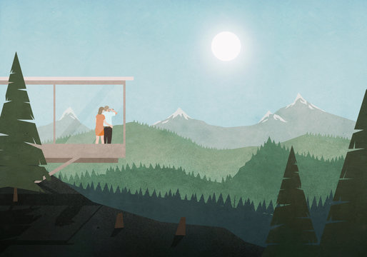 Couple looking at idyllic, sunny mountain and forest view from glass house